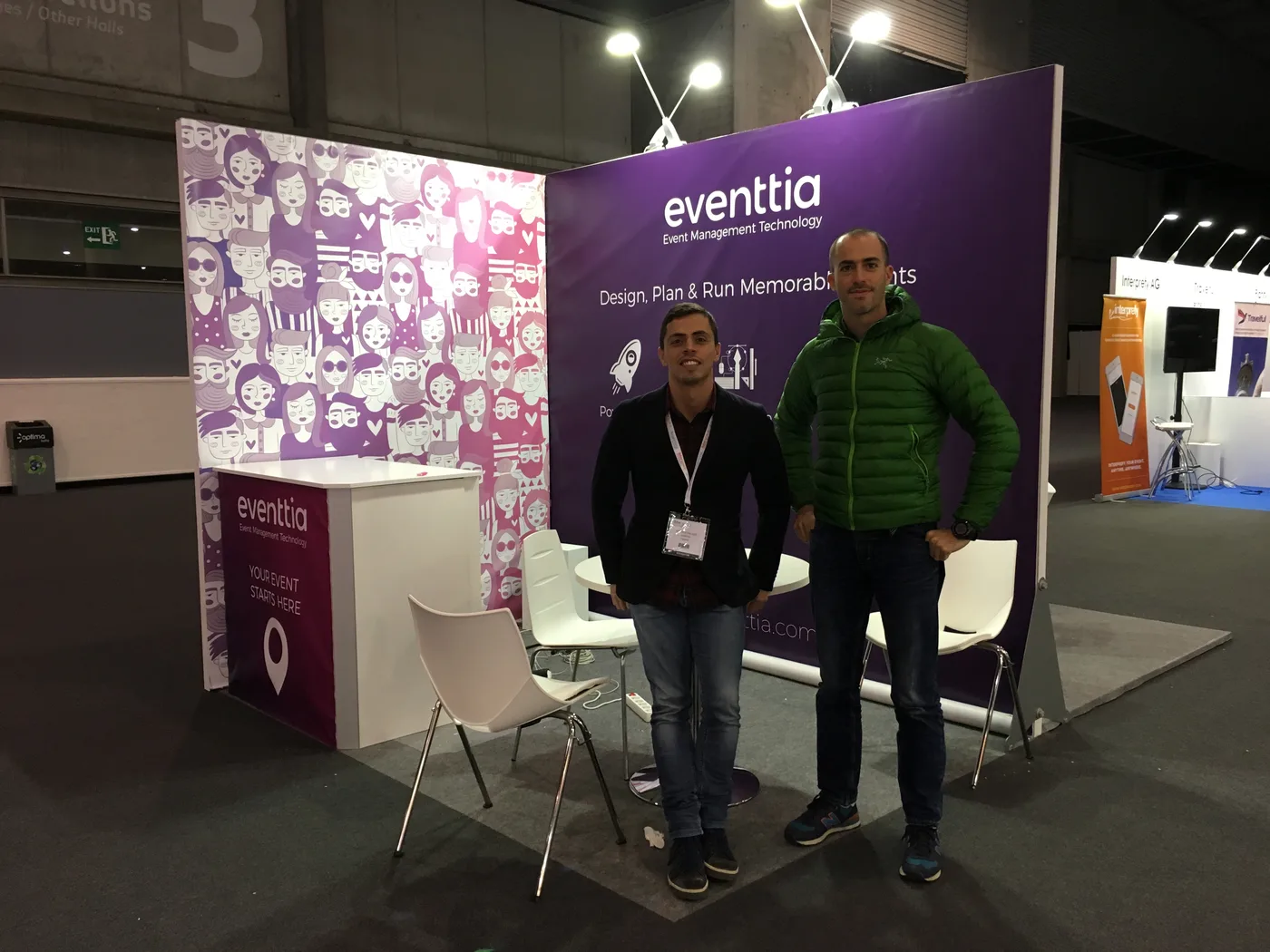 Mauricio and Esteban standing at the Eventtia booth at IBTM World 2017 in Barcelona, purple eventtia backdrop reading 'Design, Plan & Run Memorable Events' behind them.