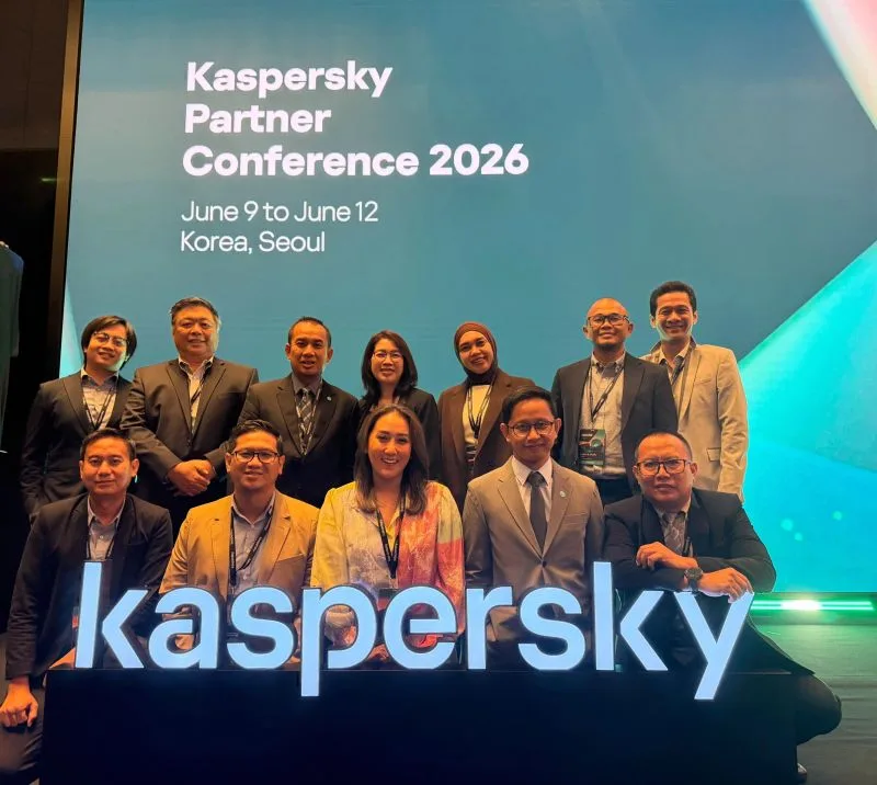 Group photo of around twelve people in business attire at the Kaspersky Partner Conference 2026 in Seoul, posed in front of a giant lit 'kaspersky' sign and a conference-branded backdrop.